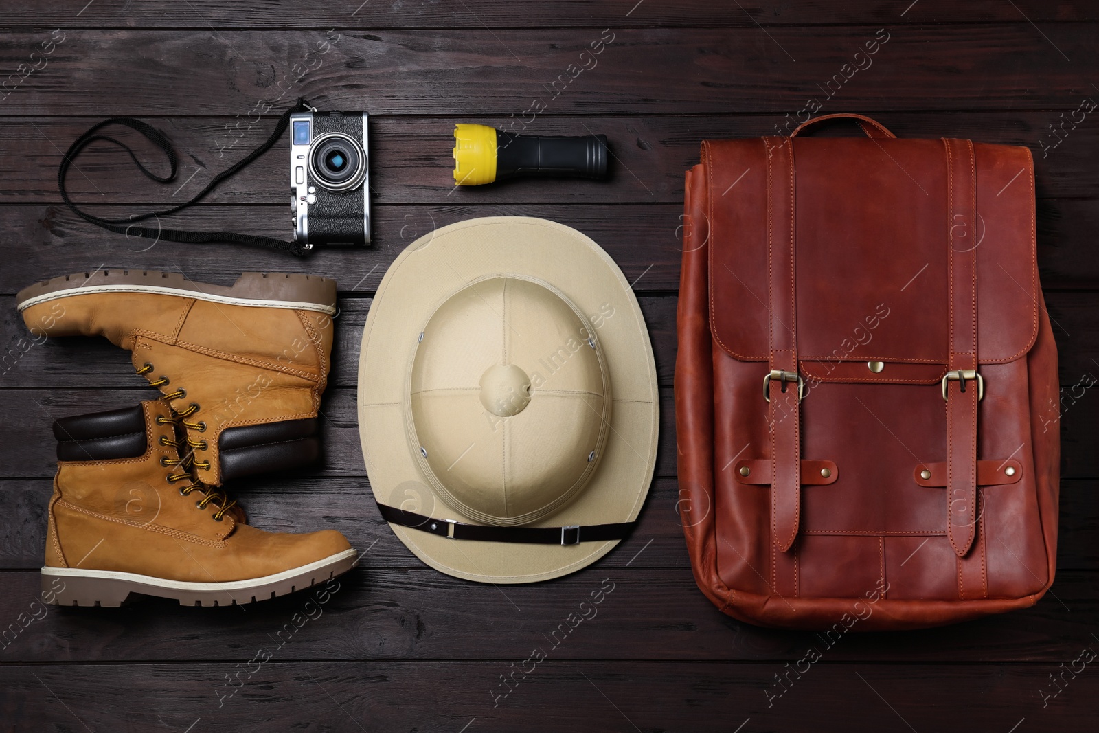 Photo of Flat lay composition with different safari accessories on wooden background