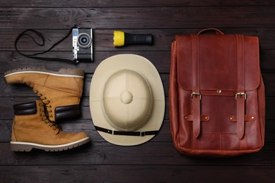 Photo of Flat lay composition with different safari accessories on wooden background