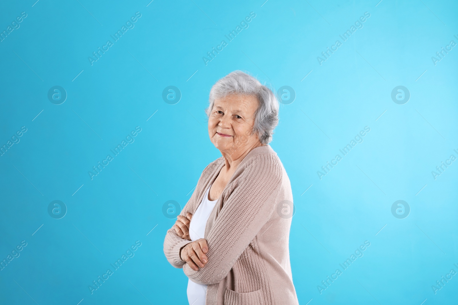 Photo of Portrait of grandmother in stylish clothes on color background