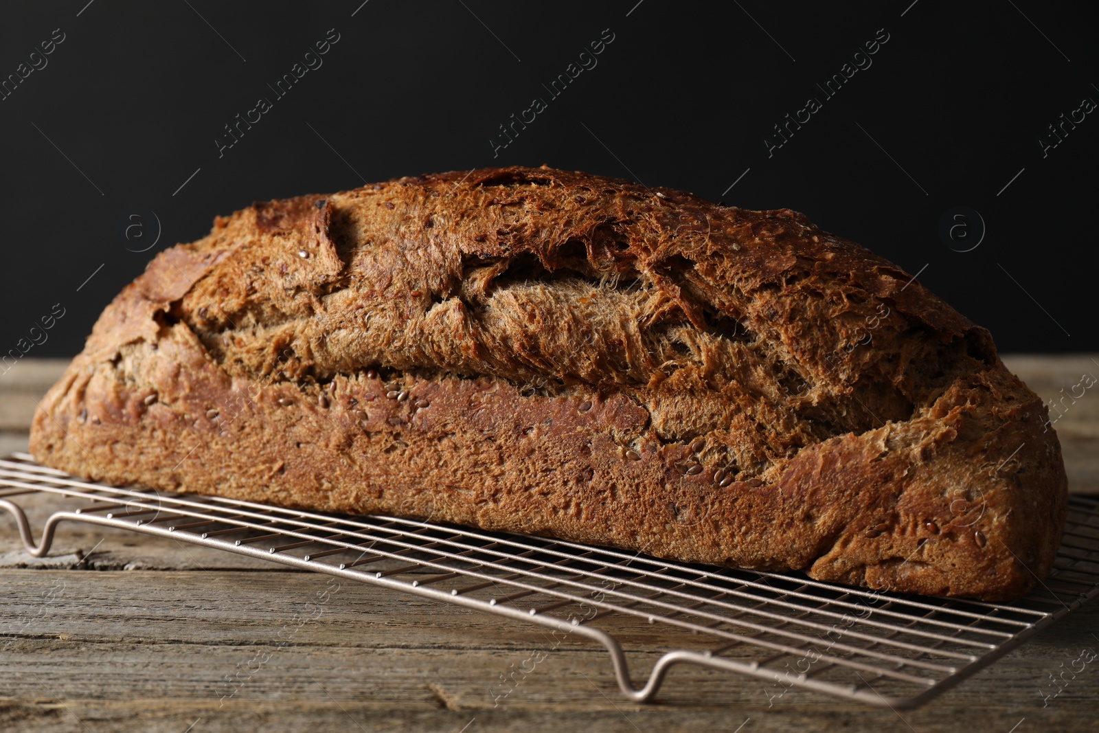 Photo of Freshly baked sourdough bread on wooden table, closeup