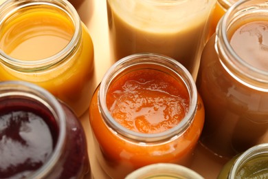 Photo of Jars with healthy baby food on table, closeup