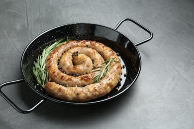 Tasty homemade sausages with spices on grey table