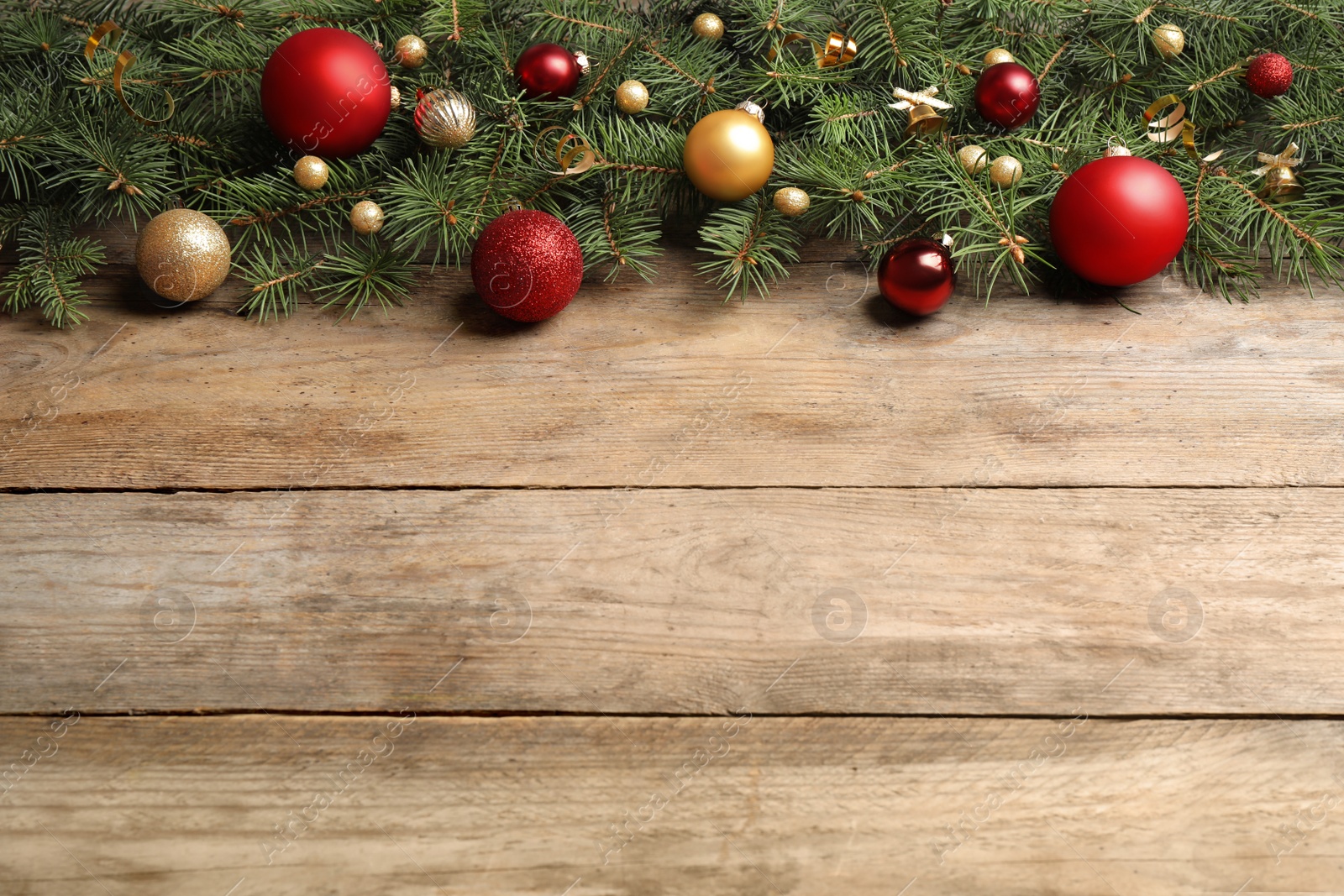 Photo of Fir tree branches with Christmas decoration on wooden background, flat lay. Space for text