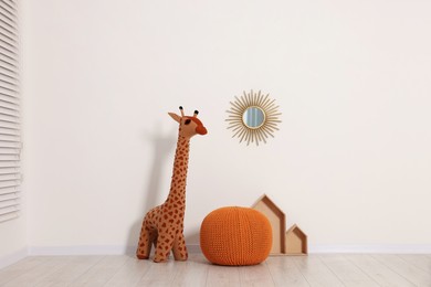 Photo of Beautiful children's room with light wall and toys. Interior design