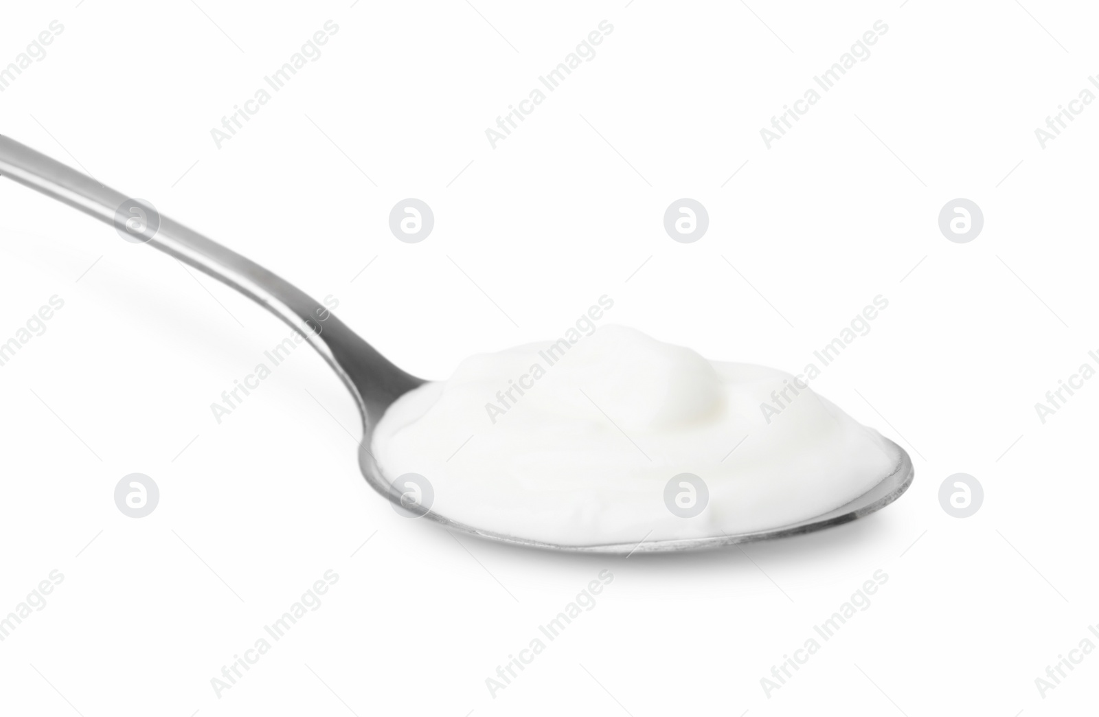 Photo of Delicious natural yogurt in spoon isolated on white