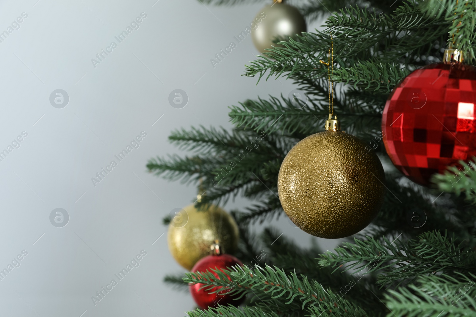 Photo of Beautiful Christmas tree with shiny baubles on white background, closeup. Space for text