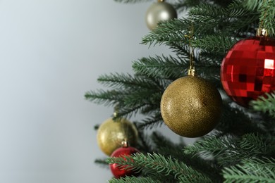 Photo of Beautiful Christmas tree with shiny baubles on white background, closeup. Space for text