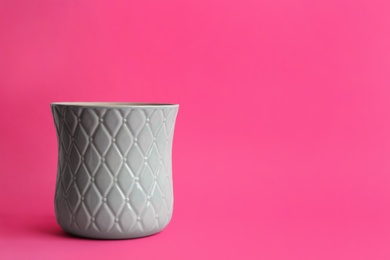 Photo of Stylish empty ceramic vase on pink background, space for text