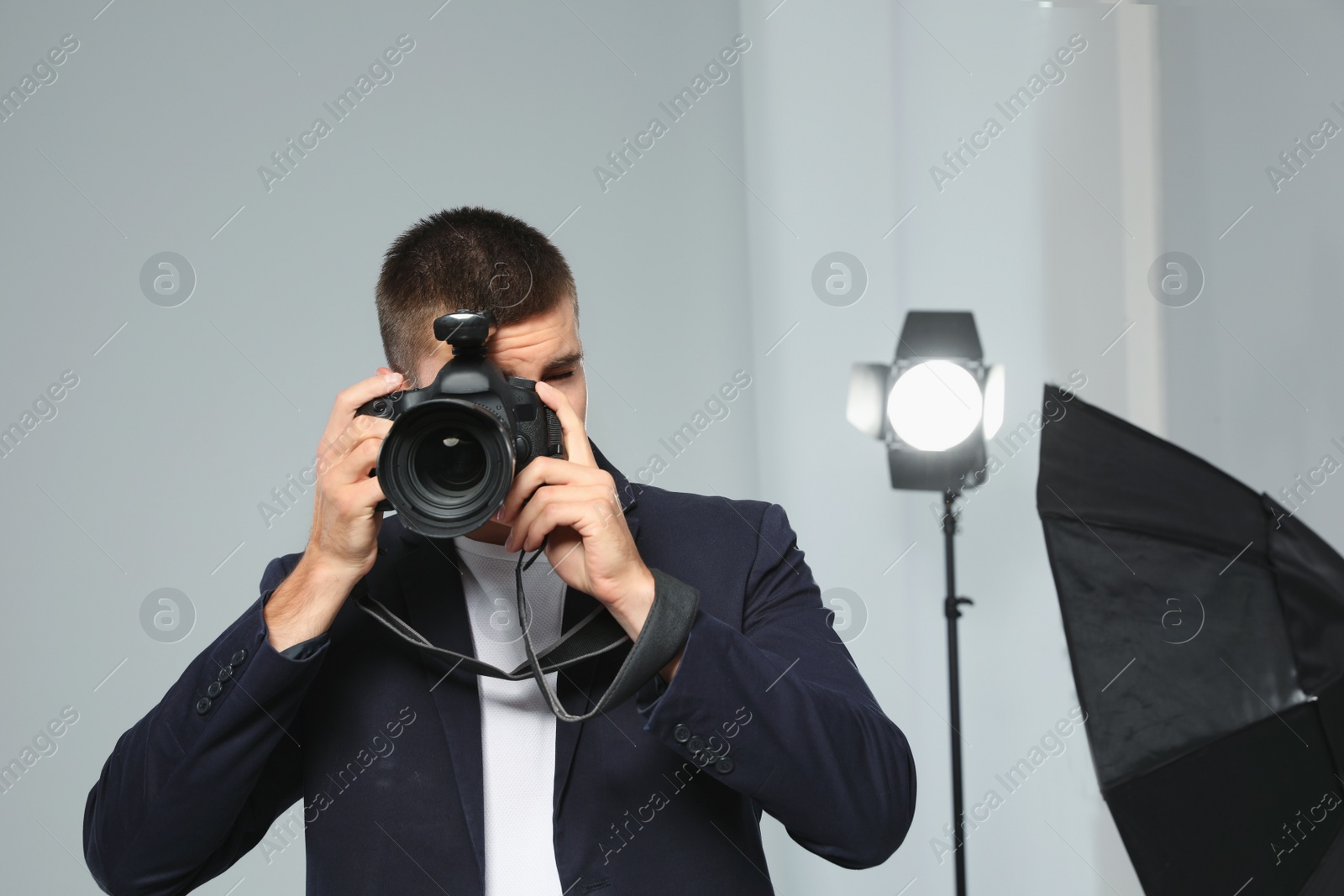 Photo of Professional photographer taking picture in modern studio