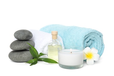 Photo of Beautiful spa composition with candle and stones on white background