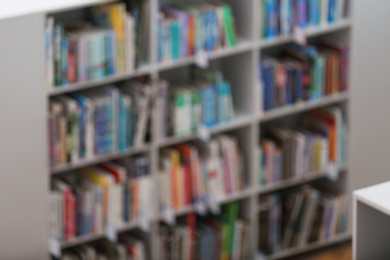 Photo of Blurred view of shelves with books in library