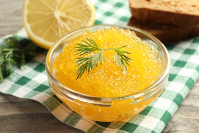 Photo of Fresh pike caviar in bowl on wooden table, closeup