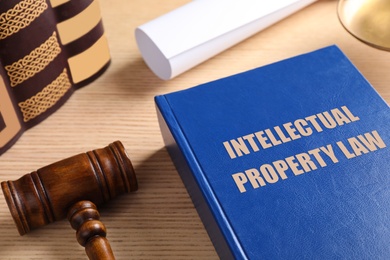 Image of Intellectual Property law book and judge's gavel on wooden table