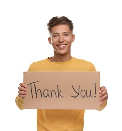 Photo of Happy man holding cardboard sheet with phrase Thank You on white background