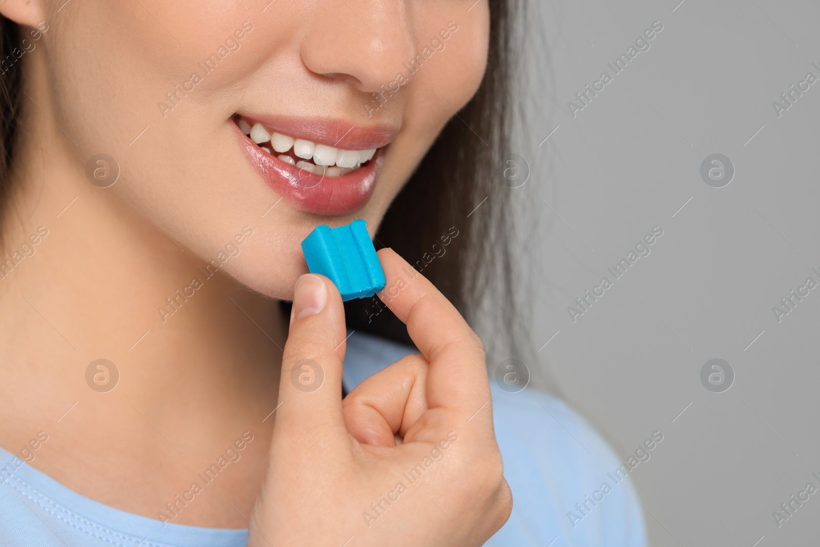 Photo of Woman with bubble gum on color background, closeup. Space for text