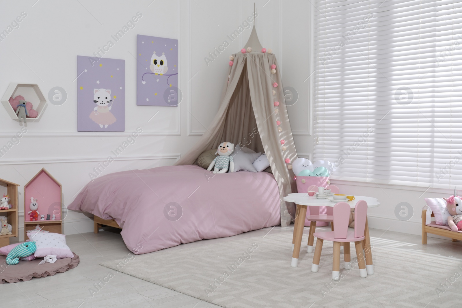 Photo of Cute child's room interior with toys and modern furniture