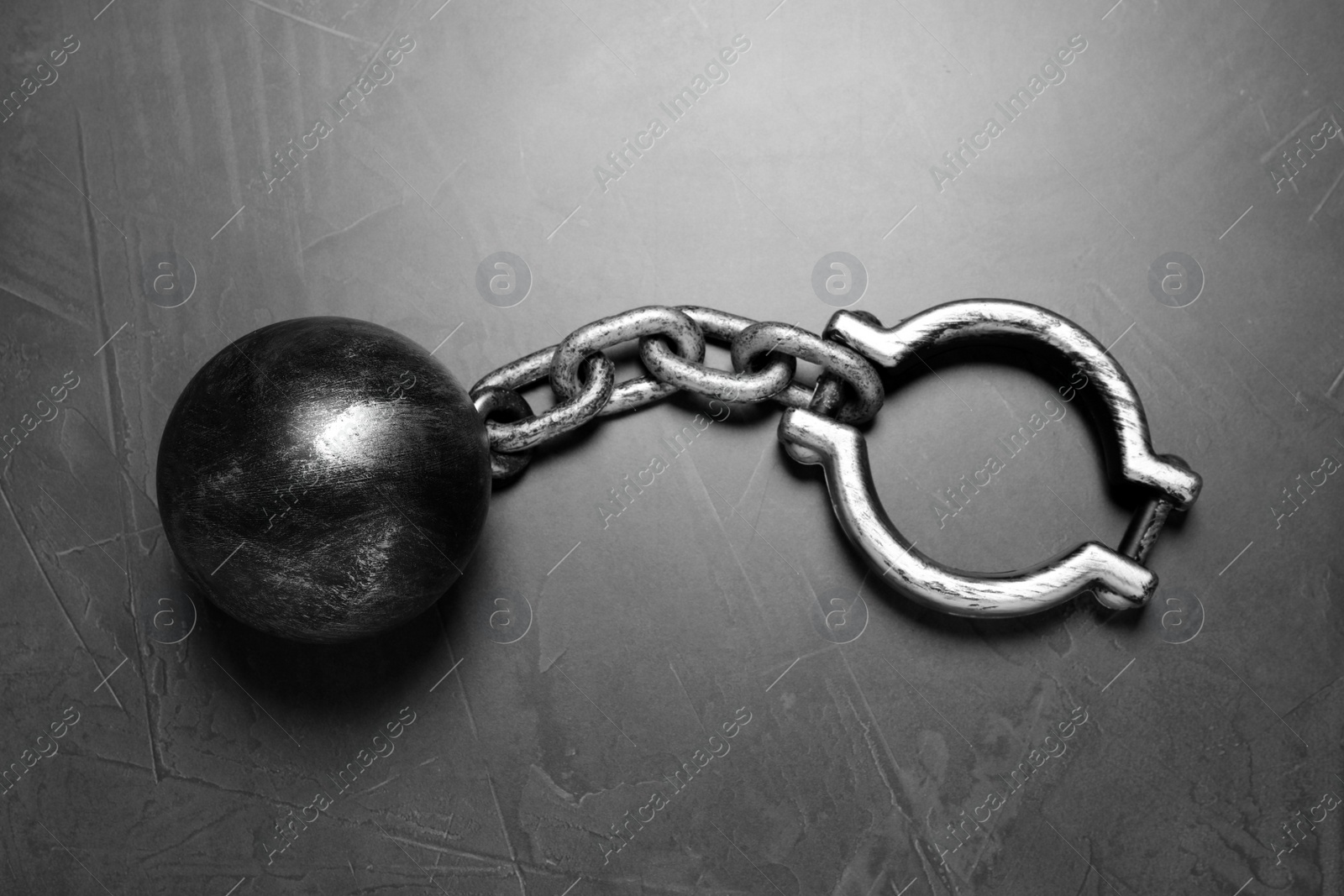 Photo of Prisoner ball with chain on grey table, top view