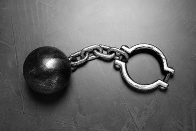 Prisoner ball with chain on grey table, top view