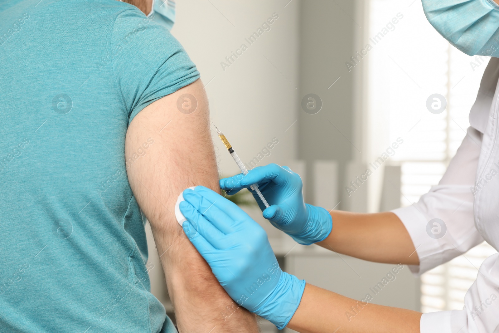 Photo of Doctor giving injection to patient in hospital, closeup. Vaccination day