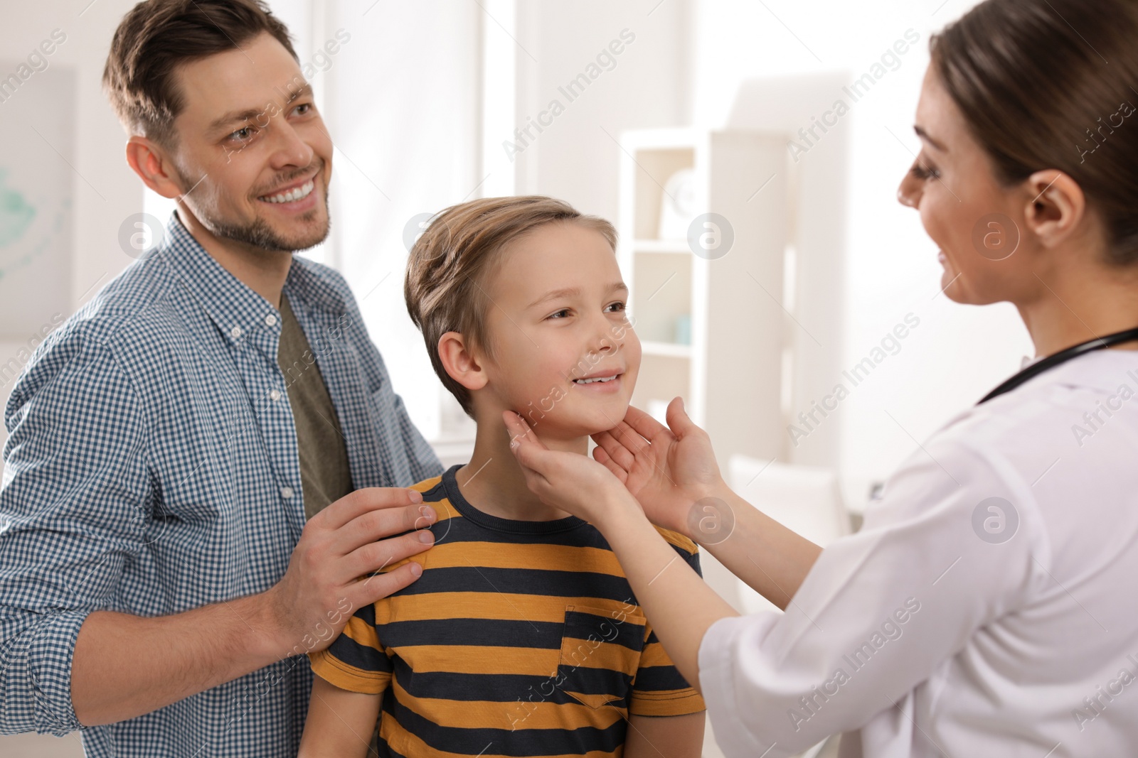 Photo of Father with child visiting doctor in hospital