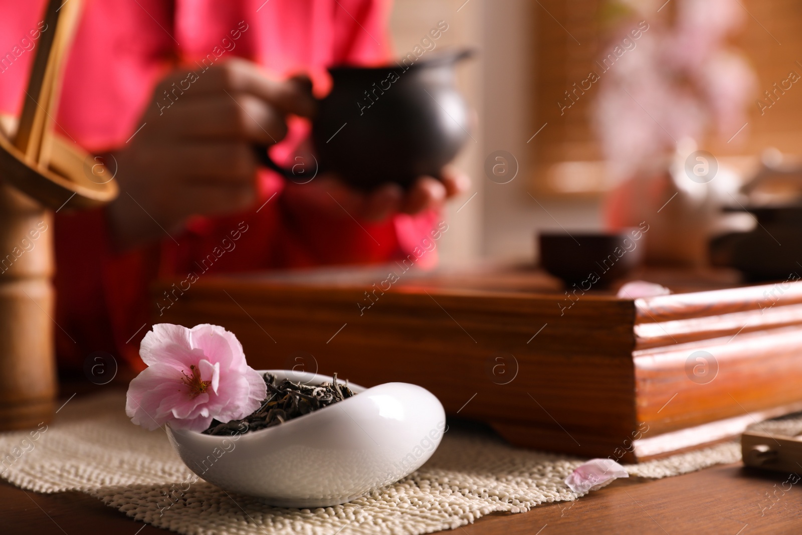 Photo of Traditional tea ceremony. Master near tray with tools, closeup