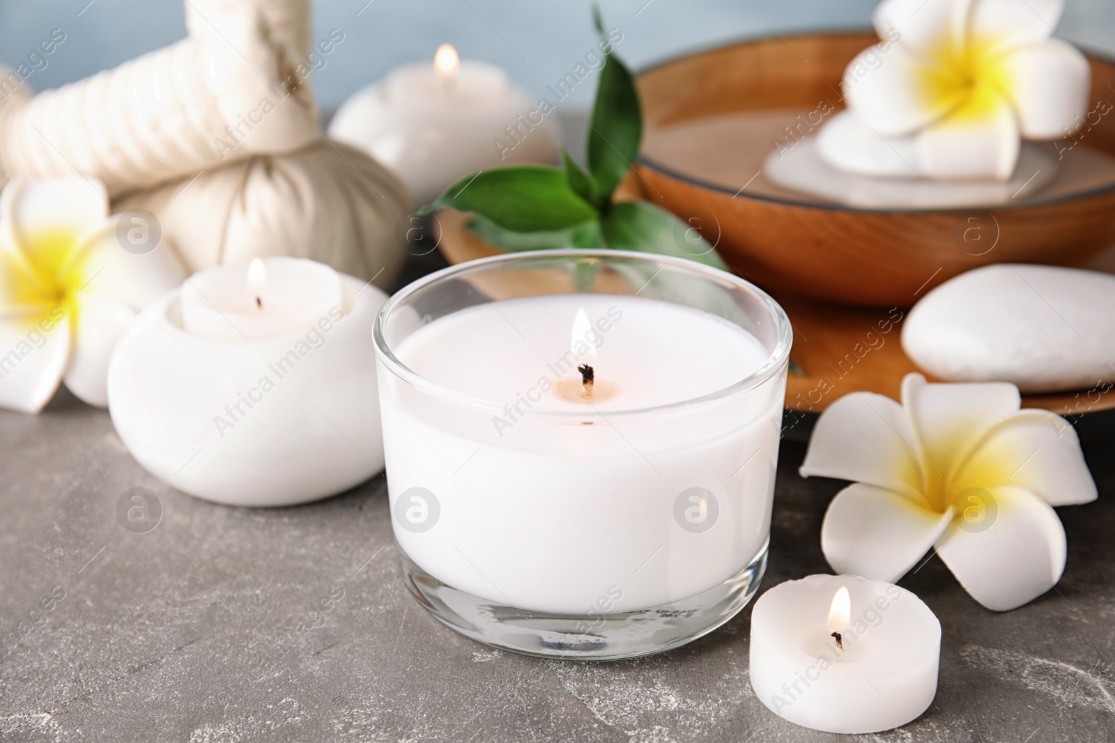 Photo of Beautiful spa composition with candles and flowers on table