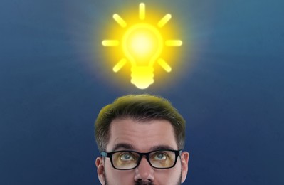 Idea generation. Man looking at illustration of glowing light bulb over him on dark blue background