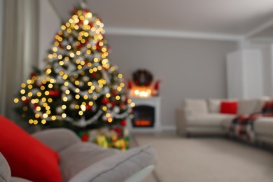 Photo of Blurred view of beautiful Christmas tree in stylish living room interior. Bokeh effect