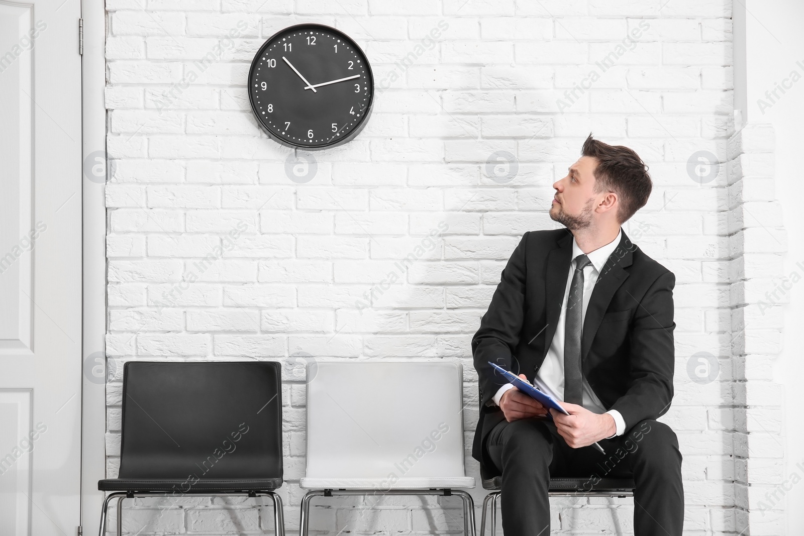 Photo of Young man waiting for job interview, indoors