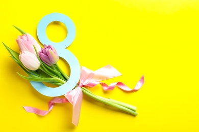 Photo of 8 March card design with tulips and space for text on yellow background, flat lay. International Women's Day