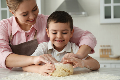 Photo of Mother and son cooking together in kitchen