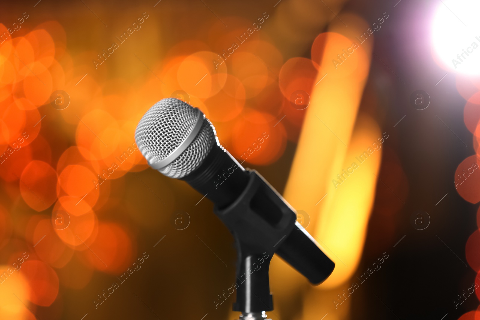 Photo of Microphone against festive lights. Musical equipment