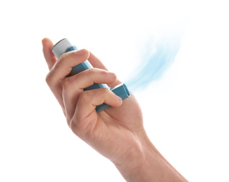 Man holding asthma inhaler with steam on white background, closeup
