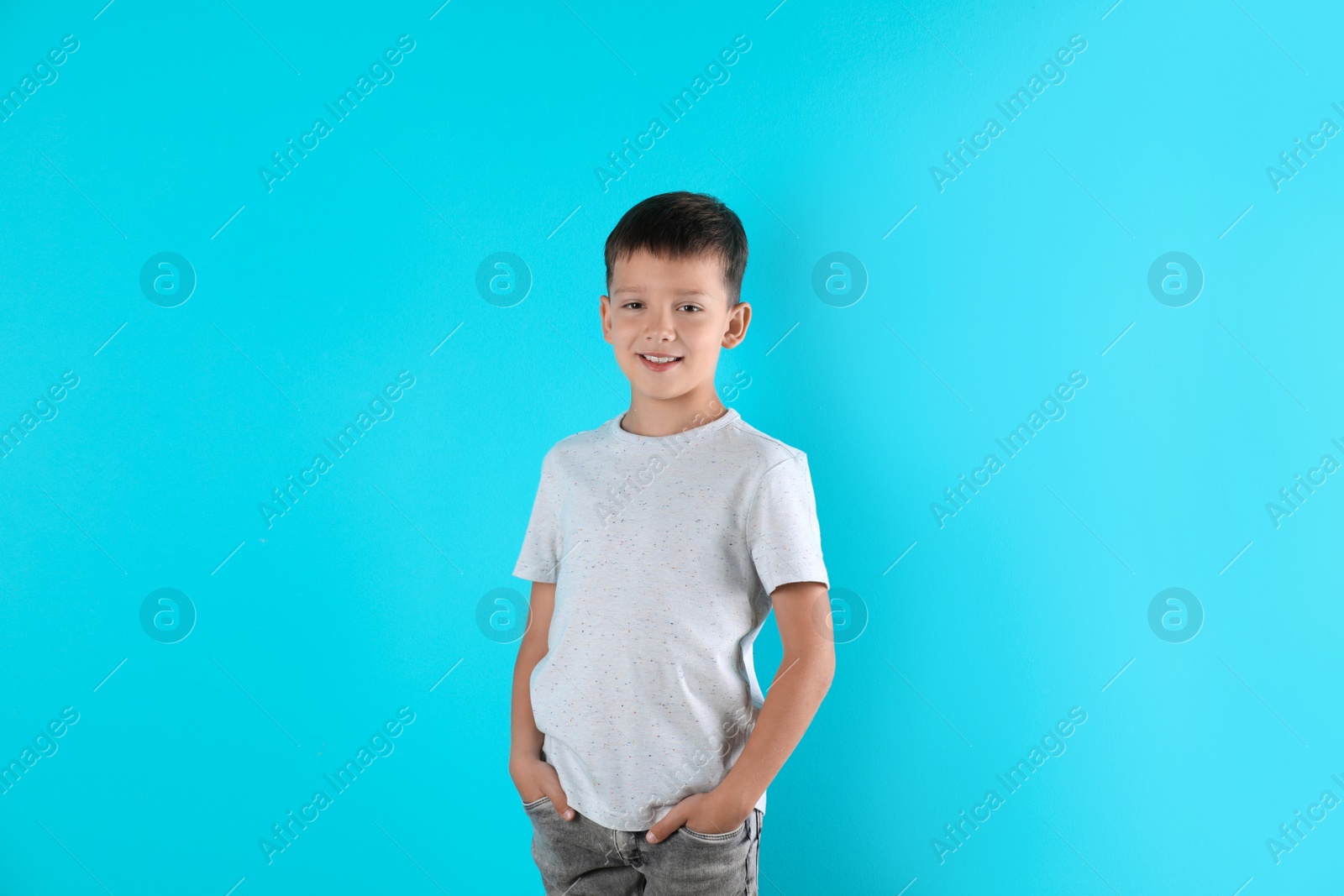 Photo of Little boy in t-shirt on color background. Mock-up for design