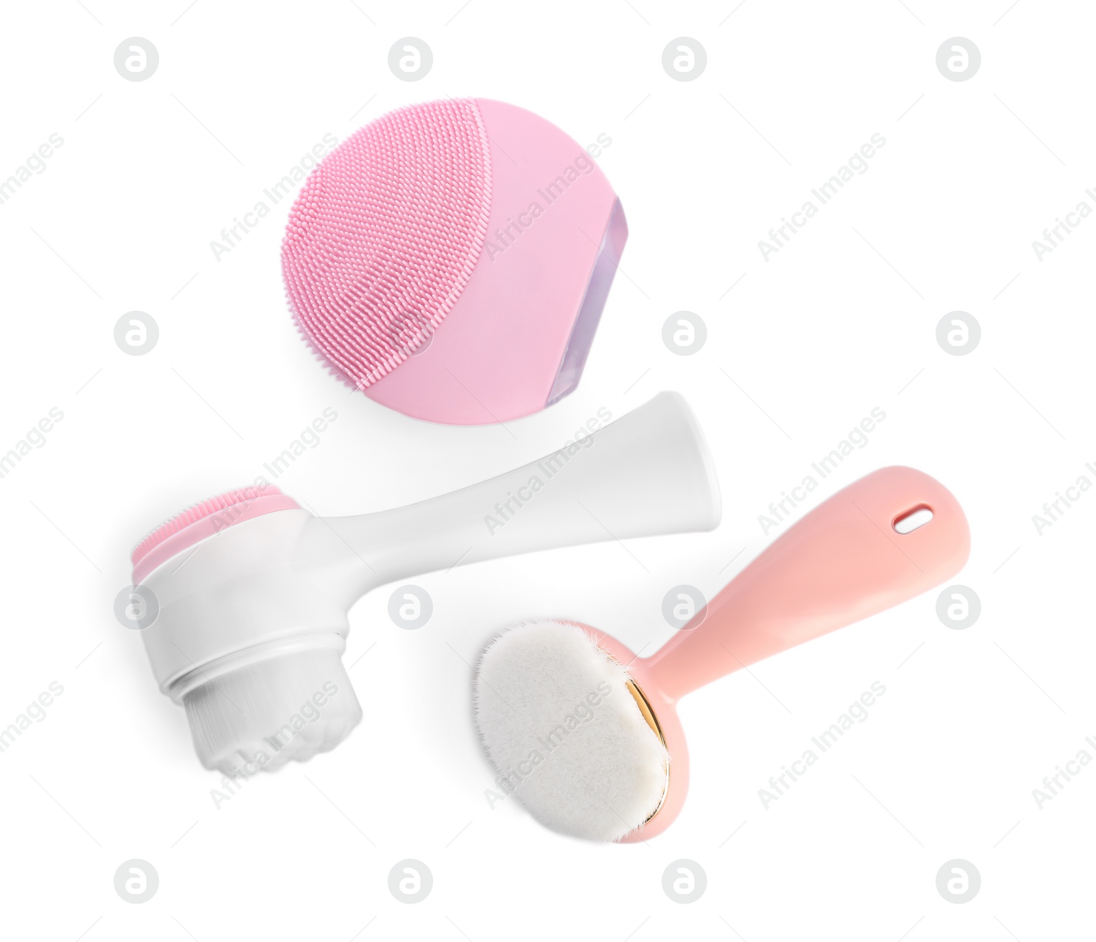 Photo of Face cleansing brushes isolated on white, top view. Cosmetic tools