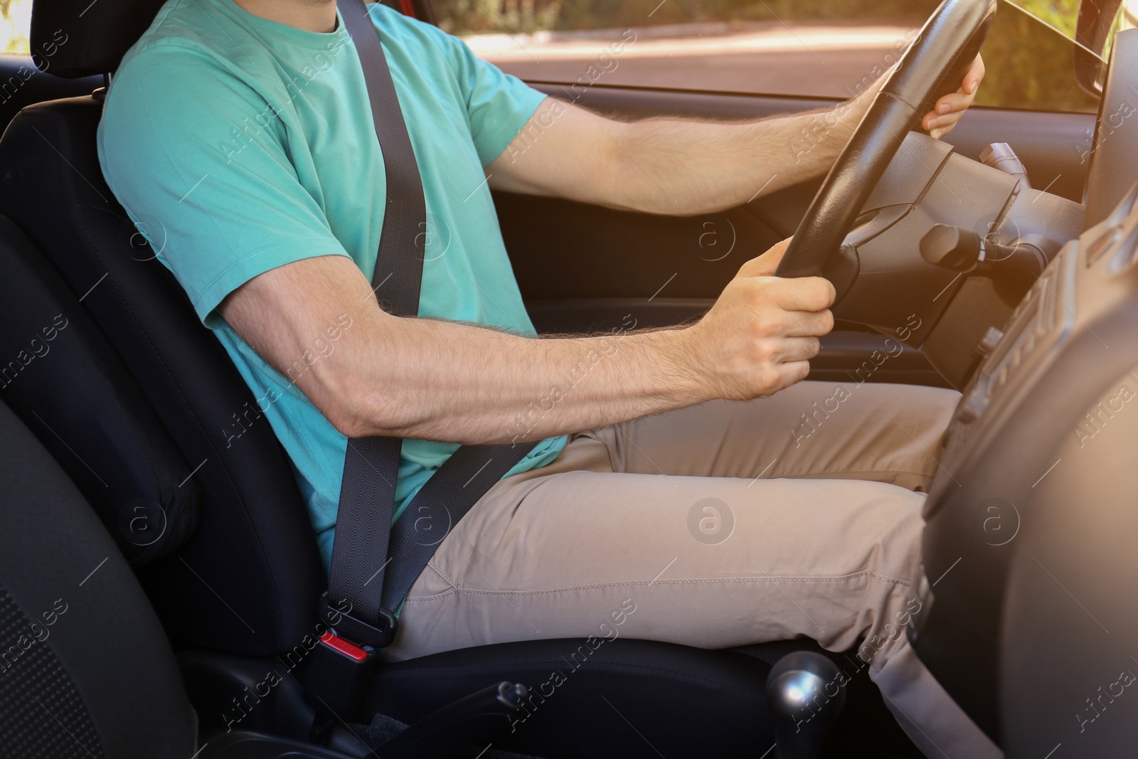 Photo of Man with fastened safety belt on driver's seat in car, closeup