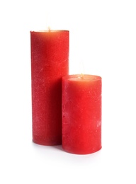 Two decorative red wax candles on white background