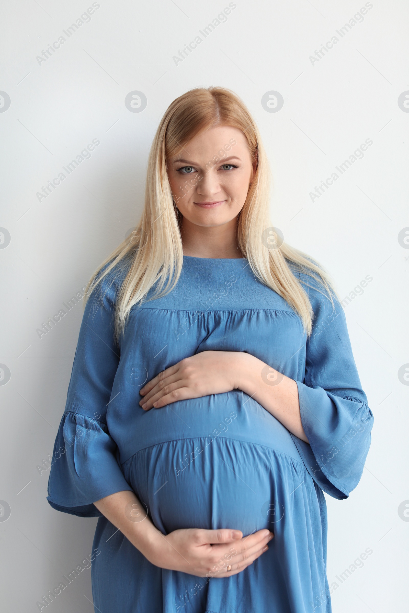 Photo of Portrait of beautiful pregnant woman on light background