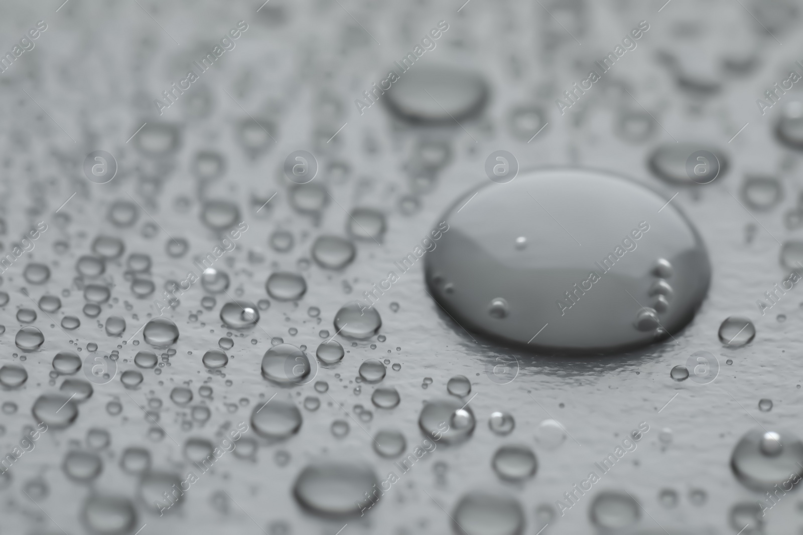 Photo of Water drops on grey background, closeup view