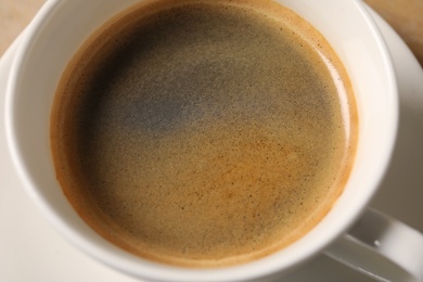 Photo of Cup of delicious hot coffee, closeup