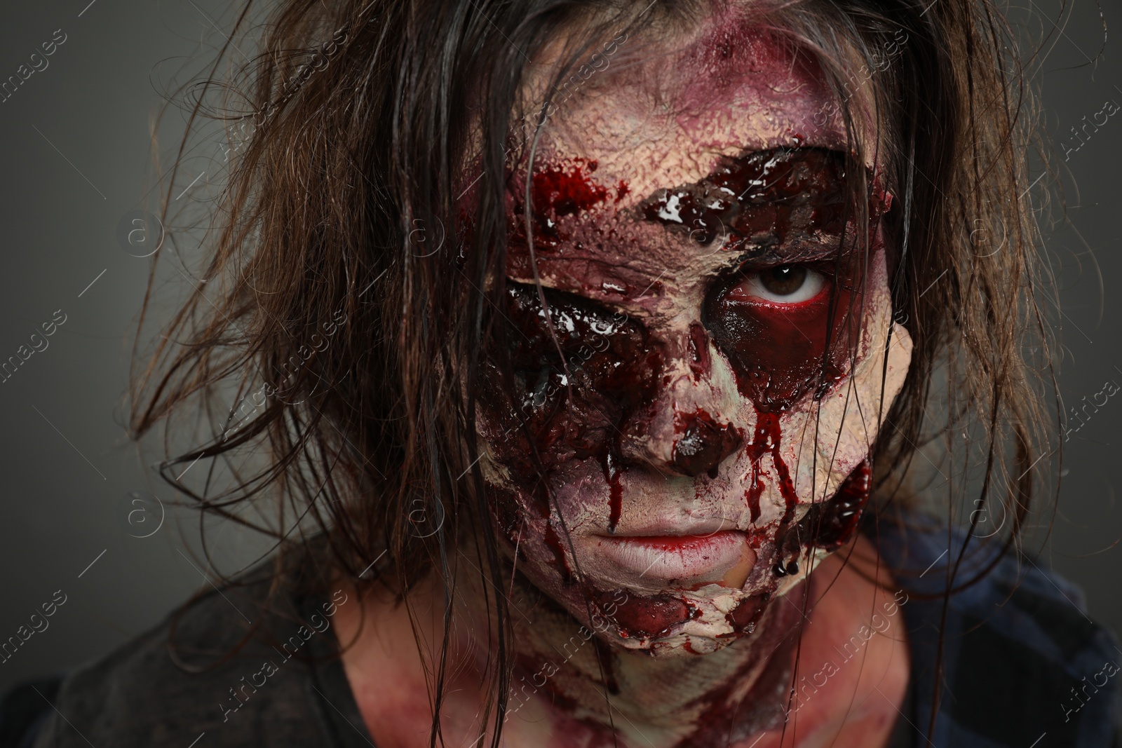 Photo of Scary zombie on dark background, closeup. Halloween monster