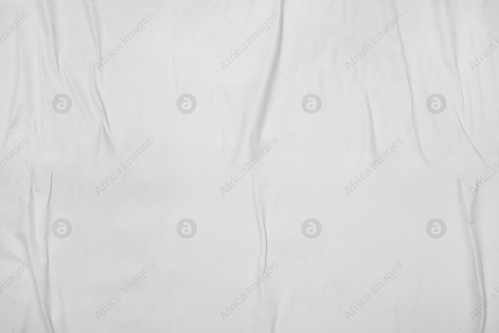 Photo of Top view of white creased blank poster as background, closeup