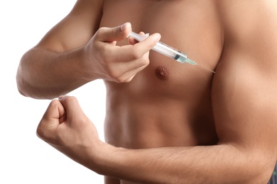 Photo of Athletic man injecting himself on white background, closeup. Doping concept