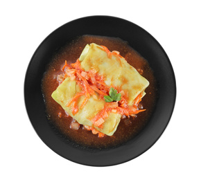 Photo of Delicious cabbage rolls with sauce isolated on white, top view