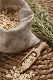 Photo of Scoop and bag with oatmeal on wicker mat