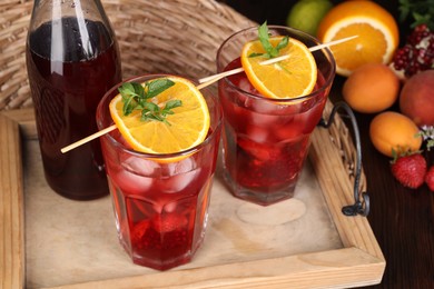 Photo of Glasses and bottle of delicious refreshing sangria on table