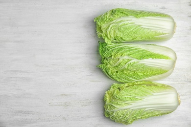 Photo of Fresh ripe cabbages on wooden background, top view