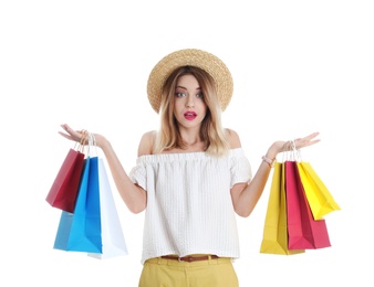 Beautiful young woman with shopping bags on white background