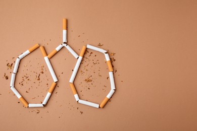 Photo of No smoking concept. Lungs made of cigarettes and dry tobacco on brown background, flat lay with space for text