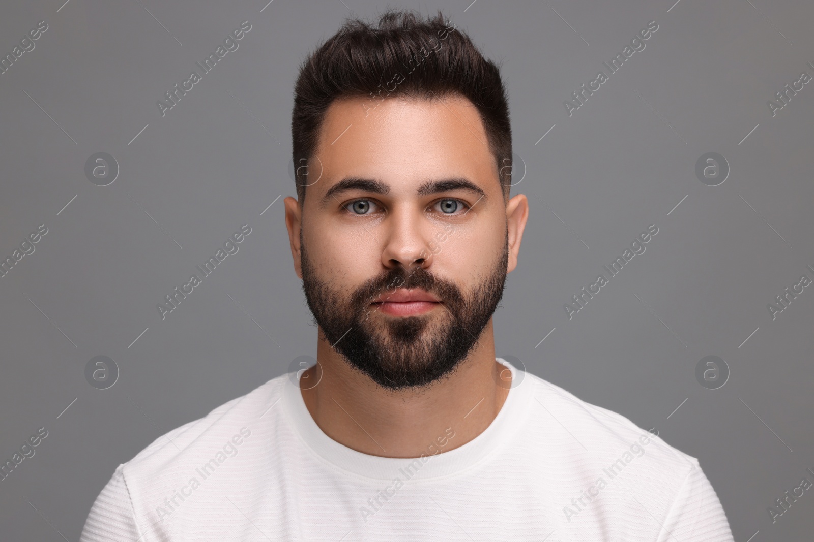 Photo of Portrait of young man on light grey background